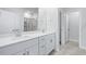 Bathroom with double sink vanity, white cabinets and an attached shower at 2024 Copper Creek Loop, Longs, SC 29568