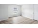 Neutral bedroom with light wood floors, one window and white trim at 2024 Copper Creek Loop, Longs, SC 29568