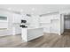 Well-lit kitchen featuring stainless appliances, large island and white cabinetry at 2024 Copper Creek Loop, Longs, SC 29568