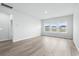 Bright living room featuring wood-look floors and large windows at 2024 Copper Creek Loop, Longs, SC 29568