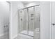 Shower with glass door, tile surround and built-in shelf at 2024 Copper Creek Loop, Longs, SC 29568