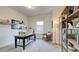 Bright home office featuring a wooden desk, chair, shelves, decor, and natural light from a large window at 2032 Copper Creek Loop, Longs, SC 29568