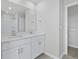 Modern bathroom featuring double sink vanity with a large mirror and stylish fixtures and hardware at 2044 Copper Creek Loop, Longs, SC 29568