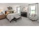 Serene bedroom featuring a king-sized bed, decorative wall art, and soft, natural light from the windows at 2044 Copper Creek Loop, Longs, SC 29568