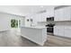 Modern kitchen with white cabinets, stainless steel appliances, and a kitchen island at 2044 Copper Creek Loop, Longs, SC 29568