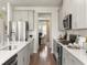 Well-lit kitchen featuring modern appliances, gray cabinets, and a view into the adjacent dining area at 2044 Copper Creek Loop, Longs, SC 29568