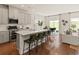 Modern kitchen open to the living area with a large island, stainless steel appliances, and hardwood floors at 2044 Copper Creek Loop, Longs, SC 29568