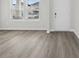 Bright living room featuring light gray wood-look flooring and natural light at 2044 Copper Creek Loop, Longs, SC 29568