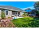 Charming backyard featuring a screened porch, patio, and well-manicured lawn at 221 Portrush Loop, Pawleys Island, SC 29585