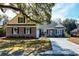 Charming brick home featuring a well-manicured lawn and an inviting, long driveway at 221 Portrush Loop, Pawleys Island, SC 29585