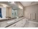 Main bathroom with a double sink vanity, large mirror and natural lighting at 221 Portrush Loop, Pawleys Island, SC 29585