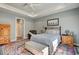 Bright main bedroom offers a large bed, patterned rug, sitting area and large window at 221 Portrush Loop, Pawleys Island, SC 29585