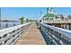 Scenic view of a wooden pier leading to a waterfront restaurant at 221 Portrush Loop, Pawleys Island, SC 29585