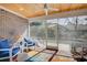 Cozy screened porch features a wood ceiling and rocking chairs for relaxing at 221 Portrush Loop, Pawleys Island, SC 29585