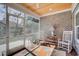 Cozy screened porch features a wood ceiling and rocking chairs for relaxing at 221 Portrush Loop, Pawleys Island, SC 29585