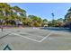 Outdoor tennis courts surrounded by mature trees and well-maintained fencing at 221 Portrush Loop, Pawleys Island, SC 29585