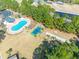 Aerial view of community amenities including a swimming pool, playground, tennis courts, and green spaces at 227 Old Hickory Dr., Conway, SC 29526