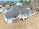 Aerial view of a home showcasing backyard patio, well-maintained lawn, and adjacent sunroom for added living space at 227 Old Hickory Dr., Conway, SC 29526