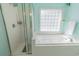 Bright bathroom features a tub, a glass block window and a step-in shower at 227 Old Hickory Dr., Conway, SC 29526