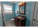 Vanity with a dark wood finish, granite countertop, and an ornate mirror offers a charming bathroom space at 227 Old Hickory Dr., Conway, SC 29526