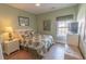 Green-painted bedroom featuring a tropical bed set, vintage art, and updated light fixture at 227 Old Hickory Dr., Conway, SC 29526