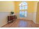 Bright dining room featuring wainscoting, hardwood floors, and large window allowing for ample natural light at 227 Old Hickory Dr., Conway, SC 29526