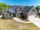 Aerial view of the brick home highlighting the well-maintained lawn, and a large driveway at 227 Old Hickory Dr., Conway, SC 29526