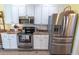 Well-equipped kitchen with stainless steel appliances, white cabinets, and wood countertops, offering modern convenience at 227 Old Hickory Dr., Conway, SC 29526