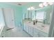 Well-lit bathroom featuring double vanity, white cabinets, large mirror, and a separate tub at 227 Old Hickory Dr., Conway, SC 29526