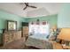 Bright main bedroom features a tray ceiling, wood furniture, and a decorative mirror at 227 Old Hickory Dr., Conway, SC 29526