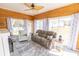 Cozy sun room with wood paneling, comfortable seating, and sliding glass doors leading to the backyard at 227 Old Hickory Dr., Conway, SC 29526