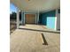 Wide carport underneath an elevated beach home with sealed garage door and painted blue walls at 2304 Seaseeker Ln., Myrtle Beach, SC 29579