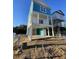 Charming two-story elevated beach home exterior features a bright, cheerful blue and white color scheme at 2304 Seaseeker Ln., Myrtle Beach, SC 29579