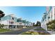 Street view of colorful coastal homes featuring elevated decks and private garages at 2304 Seaseeker Ln., Myrtle Beach, SC 29579