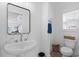 Bright half bathroom featuring pedestal sink, modern fixtures, and white wainscotting at 2306 Seaseeker Ln., Myrtle Beach, SC 29577