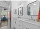 Well-lit bathroom with a double vanity, modern mirrors, and access to another bedroom at 2306 Seaseeker Ln., Myrtle Beach, SC 29577