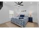 Bright bedroom with a shell themed bedspread, wood floor, ceiling fan and large windows at 2306 Seaseeker Ln., Myrtle Beach, SC 29577