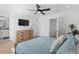 Light bedroom with a wood dresser, TV, wood floor and ensuite bath at 2306 Seaseeker Ln., Myrtle Beach, SC 29577