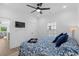 This is a bright bedroom with wood flooring and a TV, closet, and a shell themed bedspread at 2306 Seaseeker Ln., Myrtle Beach, SC 29577