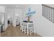 Welcoming entryway with white shiplap, dining table, and staircase leading upstairs at 2306 Seaseeker Ln., Myrtle Beach, SC 29577