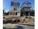 Coastal home with a blue and white exterior is elevated on pilings with construction taking place at 2306 Seaseeker Ln., Myrtle Beach, SC 29577