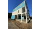 Exterior view of a home elevated on pilings and a modern design with large windows at 2306 Seaseeker Ln., Myrtle Beach, SC 29577