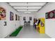 Spacious garage features fun decor, putting green, and classic arcade games at 2306 Seaseeker Ln., Myrtle Beach, SC 29577