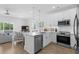 Bright, open kitchen with white cabinetry, stainless steel appliances, and a view to the living area at 2306 Seaseeker Ln., Myrtle Beach, SC 29577