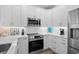 Modern kitchen with stainless steel appliances, white cabinets, and stylish countertops at 2306 Seaseeker Ln., Myrtle Beach, SC 29577