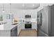 Modern kitchen with stainless steel appliances, white cabinets, and quartz countertops at 2306 Seaseeker Ln., Myrtle Beach, SC 29577