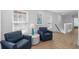 Sitting area with two blue chairs, side table, hard wood floor, and a beachy art print at 2306 Seaseeker Ln., Myrtle Beach, SC 29577