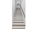 Bright stairway with white risers, wood treads, and wooden handrail at 2306 Seaseeker Ln., Myrtle Beach, SC 29577