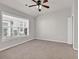 This bedroom features natural light, neutral carpet, and a ceiling fan at 2454 N Windmill Way, Myrtle Beach, SC 29579