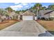 Beautiful brick home featuring a two-car garage, manicured lawn, and a spacious driveway at 2454 N Windmill Way, Myrtle Beach, SC 29579